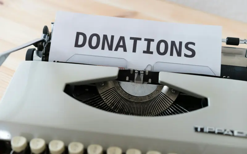 Typewriter with a donations sign