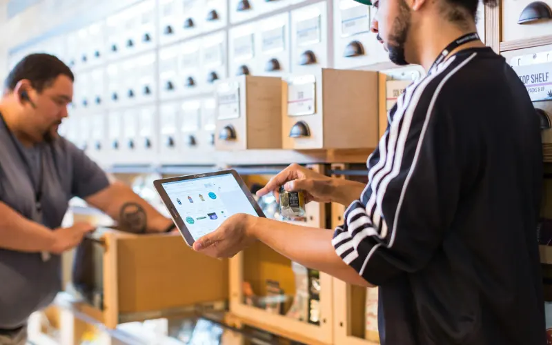 Supplier checking stock on a tablet in a store