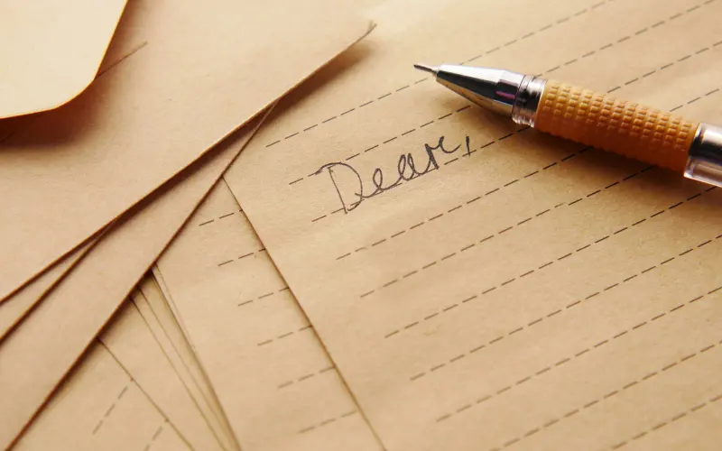 Pen resting on a handwritten letter