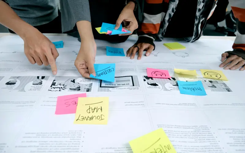 Team planning a project with sticky notes on a table