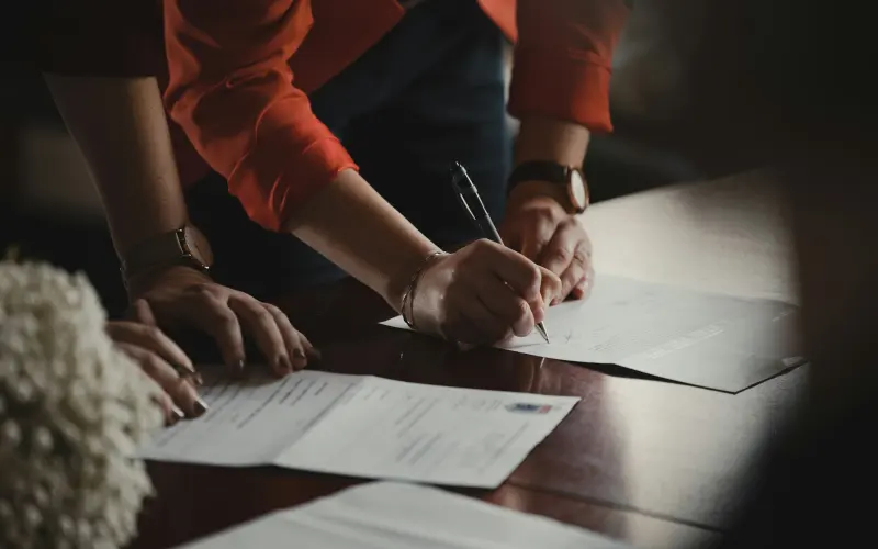 Partners signing documents at a table