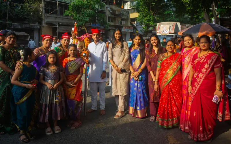 Community group gathered outdoors in traditional dress